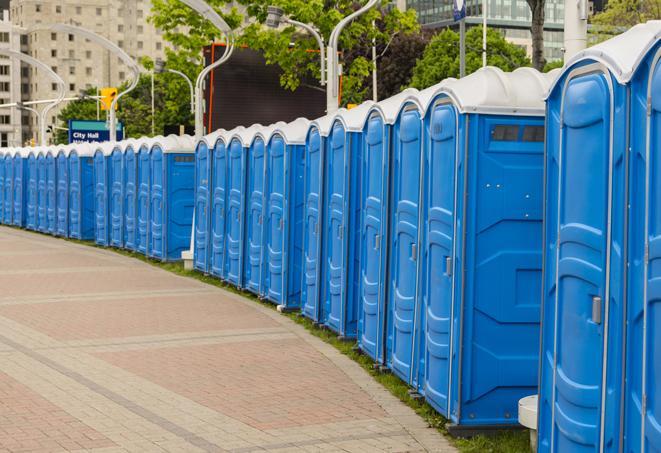 a row of sleek and modern portable restrooms at a special outdoor event in Ackermanville